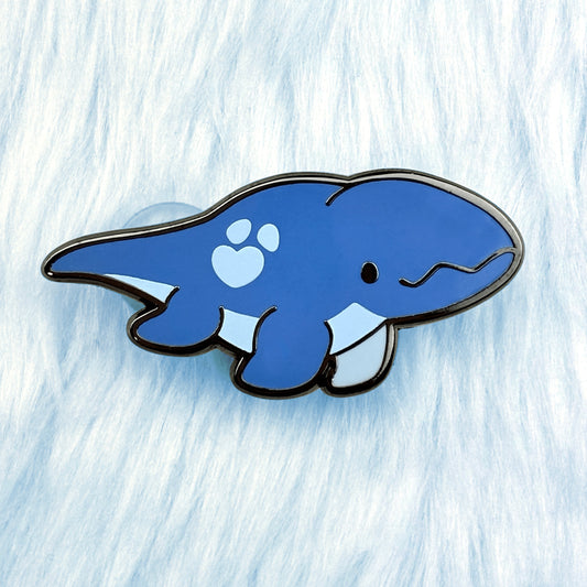 Cute dinosaur enamel pin of a blue mosasaurus with a light blue belly and loveheart spot.