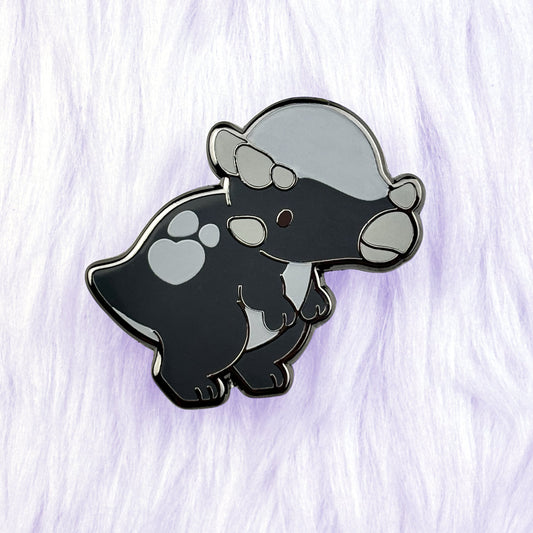 cute dinosaur enamel pin of a black and grey pachycephalosaurus with a loveheart spot and black nickel plating.