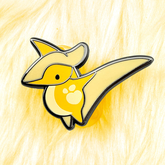 cute dinosaur enamel pin of a pterodactyl with yellow colors and black nickel plating.